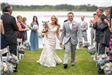 Bride and groom walking down the aisle with a dog
