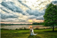 Bride and groom in front of lake