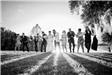 Black and white photo of bride and groom with bridal party
