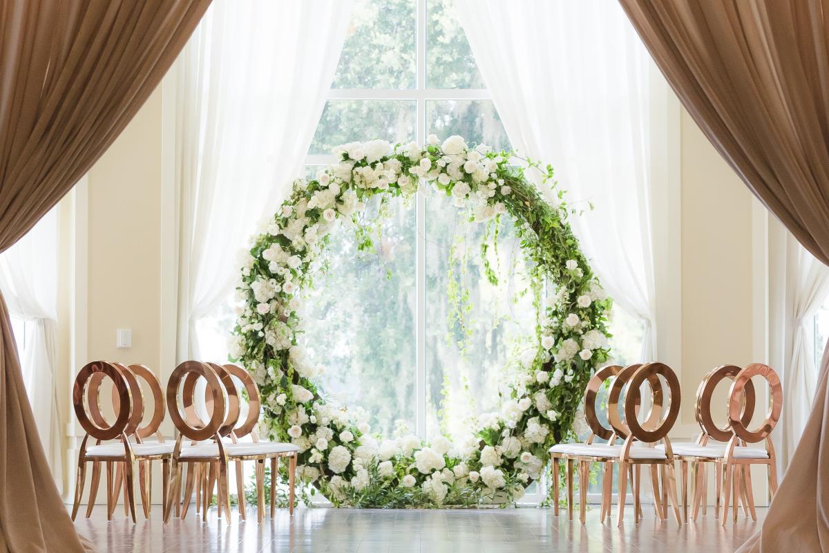 Indoor wedding setting with large flower ring