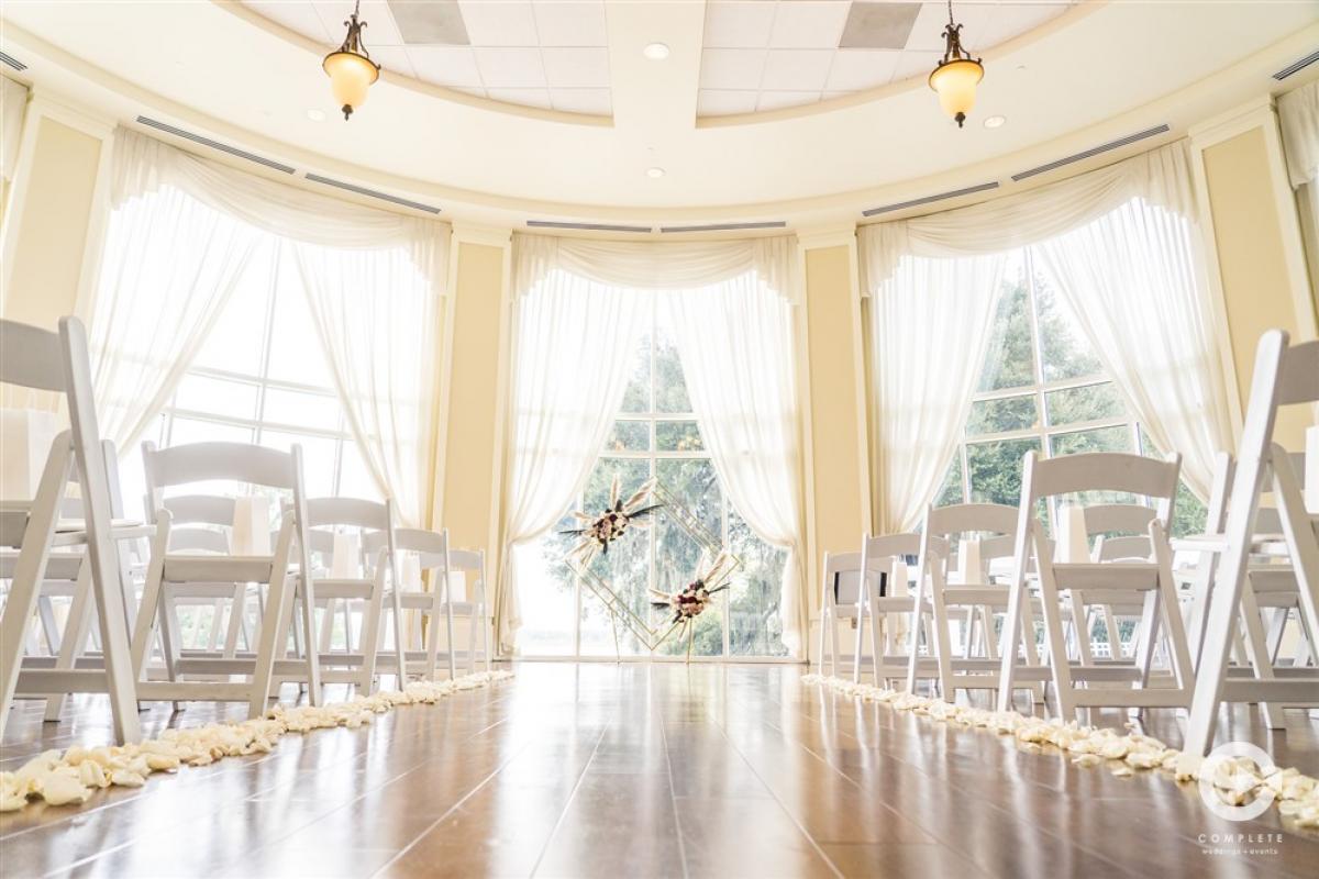 Indoor wedding ceremony with aisle decoration