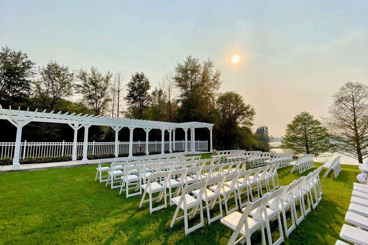 Outdoor wedding ceremony setting with pergola