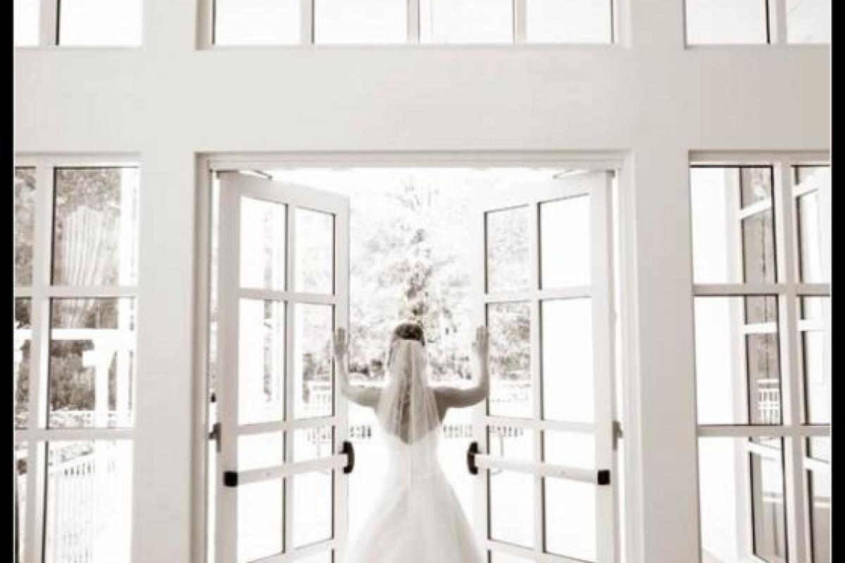 Bride standing in front of double doors