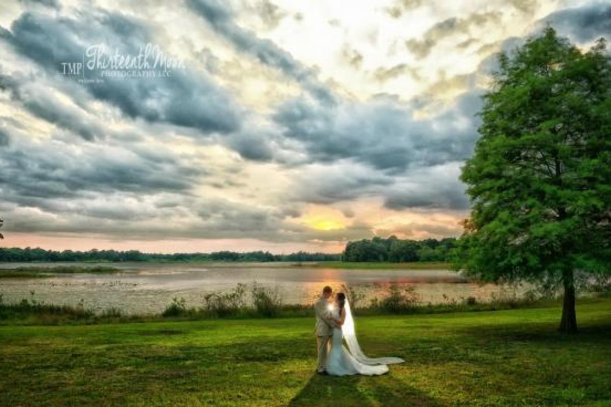 Bride and groom in front of lake