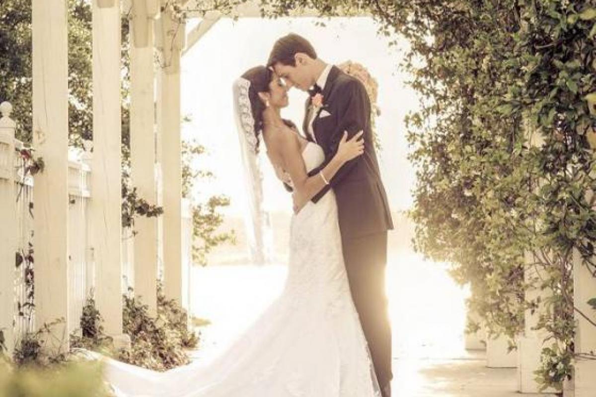 Bride and groom underneath archway