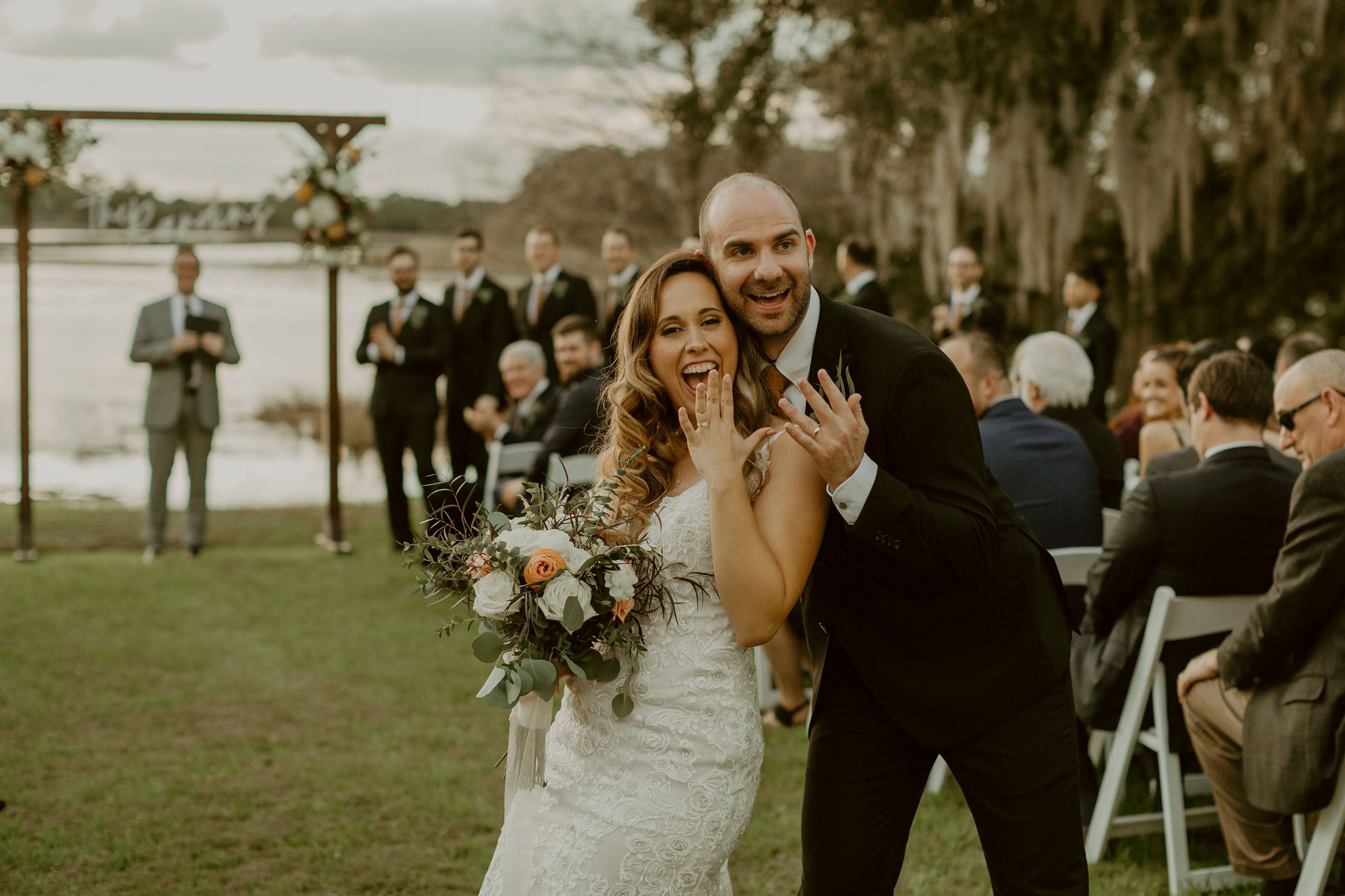 Bride and Groom showing off rings after ceremony